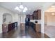 A modern kitchen featuring dark wood cabinets, granite countertops, and stainless steel appliances at 3535 Clarecastle Dr, Buford, GA 30519