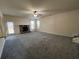 Open living room with fireplace, carpet, and access to backyard and stairs at 3535 Clarecastle Dr, Buford, GA 30519