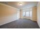 Spacious living room with bay window, neutral paint and plush gray carpeting at 3535 Clarecastle Dr, Buford, GA 30519