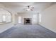 Inviting living room featuring a fireplace, modern ceiling fan, and seamless flow to the kitchen at 3535 Clarecastle Dr, Buford, GA 30519