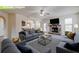 Inviting living room featuring a cozy fireplace, ceiling fan, and plenty of comfortable seating at 3535 Clarecastle Dr, Buford, GA 30519