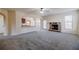 Bright living room with stone fireplace, modern ceiling fan, and open access to kitchen at 3535 Clarecastle Dr, Buford, GA 30519