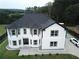 Two-story house with a black roof, white siding, and a large driveway at 7540 Union Grove Rd, Lithonia, GA 30058