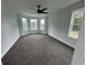 Spacious bedroom with bay window, ceiling fan, and carpet at 7540 Union Grove Rd, Lithonia, GA 30058