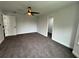 Bright bedroom featuring a ceiling fan and neutral carpeting at 7540 Union Grove Rd, Lithonia, GA 30058