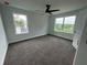 Serene bedroom with ceiling fan, carpet, and large windows at 7540 Union Grove Rd, Lithonia, GA 30058