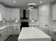 Modern kitchen with white cabinets, quartz countertops and island at 7540 Union Grove Rd, Lithonia, GA 30058