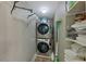 Convenient laundry area with washer, dryer, and storage shelves at 100 Verlaine Nw Pl, Atlanta, GA 30327