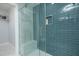 Modern bathroom with walk-in shower, marble tile, and glass enclosure at 1482 Andrews Nw St, Atlanta, GA 30314