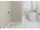 Bathroom with tile floor, granite vanity and laundry area at 3489 Pine Forest Se Dr, Atlanta, GA 30354