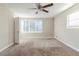 Bright bedroom with carpeted floor, large window, and ceiling fan at 3489 Pine Forest Se Dr, Atlanta, GA 30354