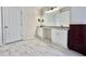 Modern bathroom featuring double vanity and updated flooring at 3877 Oakman Pl, Fairburn, GA 30213