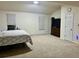 Spacious bedroom with vaulted ceiling and carpeted floor at 3877 Oakman Pl, Fairburn, GA 30213