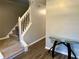 Entryway with staircase, glass-top table, and wood-look floors at 3877 Oakman Pl, Fairburn, GA 30213