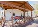 Relaxing back porch with wooden seating and string lights at 511 Laird Rd, Hiram, GA 30141