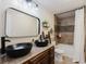 Bathroom with double vanity, black vessel sinks, and a shower/tub combo at 511 Laird Rd, Hiram, GA 30141