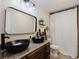 Bathroom with double vanity, black vessel sinks, and a shower/tub combo at 511 Laird Rd, Hiram, GA 30141