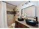 Bathroom with double vanity, black vessel sinks, and a shower/tub combo at 511 Laird Rd, Hiram, GA 30141