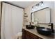 Bathroom with double vanity, black vessel sinks, and a shower/tub combo at 511 Laird Rd, Hiram, GA 30141