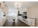 Farmhouse-style dining area with a long wooden table and white chairs at 511 Laird Rd, Hiram, GA 30141