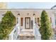 Inviting front porch with white railings and stylish lanterns at 511 Laird Rd, Hiram, GA 30141