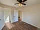 Bedroom with hardwood floors, ceiling fan and access to another room at 11868 Fairway Overlook, Fayetteville, GA 30215