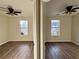 Two bedrooms with hardwood floors and ceiling fans at 11868 Fairway Overlook, Fayetteville, GA 30215