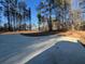 Long concrete driveway leading to a house in a wooded area at 2259 Old Yorkville Rd, Dallas, GA 30157