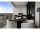 Outdoor dining on balcony with grill and views of surrounding greenery at 2520 Peachtree Nw Rd # 1202, Atlanta, GA 30305