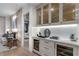 Dry bar with custom shelving and wine refrigerators, adjacent to the living area and bedroom at 2520 Peachtree Nw Rd # 1202, Atlanta, GA 30305