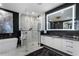 Stylish bathroom with frameless glass shower, soaking tub, white cabinets, and marble flooring at 2520 Peachtree Nw Rd # 1202, Atlanta, GA 30305