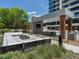 Outdoor common area with fire pit, large TV, and table with chairs near the swimming pool at 2520 Peachtree Nw Rd # 1202, Atlanta, GA 30305