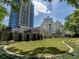 Lush green lawn with mature trees surrounding modern buildings, offering a serene outdoor space at 2520 Peachtree Nw Rd # 1202, Atlanta, GA 30305