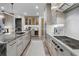 Bright and airy kitchen features marble countertops, stainless steel appliances, custom lighting, and wood floors at 2520 Peachtree Nw Rd # 1202, Atlanta, GA 30305