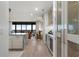 Open-concept living area features a bar, modern cabinetry, and scenic views through large windows at 2520 Peachtree Nw Rd # 1202, Atlanta, GA 30305