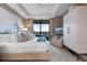 This luxurious main bedroom features a private balcony, light walls, and modern furnishings at 2520 Peachtree Nw Rd # 1202, Atlanta, GA 30305