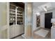 Custom pantry features decorative doors, ample shelving for storage, and convenient bar area at 2520 Peachtree Nw Rd # 1202, Atlanta, GA 30305