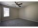 Simple bedroom with ceiling fan and neutral wall color at 4553 Carriage Park Dr, Lithonia, GA 30038