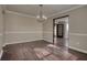 Dining room with hardwood floors and chandelier, adjacent to kitchen at 4553 Carriage Park Dr, Lithonia, GA 30038