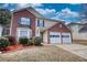 Two-story home with brick and siding exterior at 4553 Carriage Park Dr, Lithonia, GA 30038