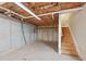 Unfinished basement with exposed walls, insulation, and wooden stairs at 811 Somersby Dr, Dallas, GA 30157