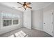 Bedroom with a ceiling fan and a bright window, perfect for relaxation and comfort at 811 Somersby Dr, Dallas, GA 30157