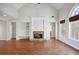 Spacious living room featuring a stone fireplace, built-in shelving, and large windows with natural light at 811 Somersby Dr, Dallas, GA 30157