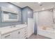 Modern bathroom with white vanity, gray walls, and a shower/tub combo at 93 Highway 81, Oxford, GA 30054