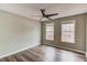 Bedroom with two windows offering natural light and a modern ceiling fan at 93 Highway 81, Oxford, GA 30054
