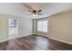 Bedroom featuring wood floors, a ceiling fan and an ensuite bath with a double vanity at 93 Highway 81, Oxford, GA 30054