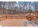 Wooden deck with a fenced perimeter and stairs leading to the backyard at 93 Highway 81, Oxford, GA 30054