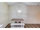 Simple dining room with neutral walls, wood floors, and wooden chairs and benches at 93 Highway 81, Oxford, GA 30054