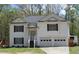 Charming two-story home with a well-manicured lawn, two car garage and a quaint front porch at 93 Highway 81, Oxford, GA 30054