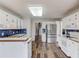 Spacious kitchen featuring stainless steel appliances, ample white cabinetry, and hardwood floors at 93 Highway 81, Oxford, GA 30054